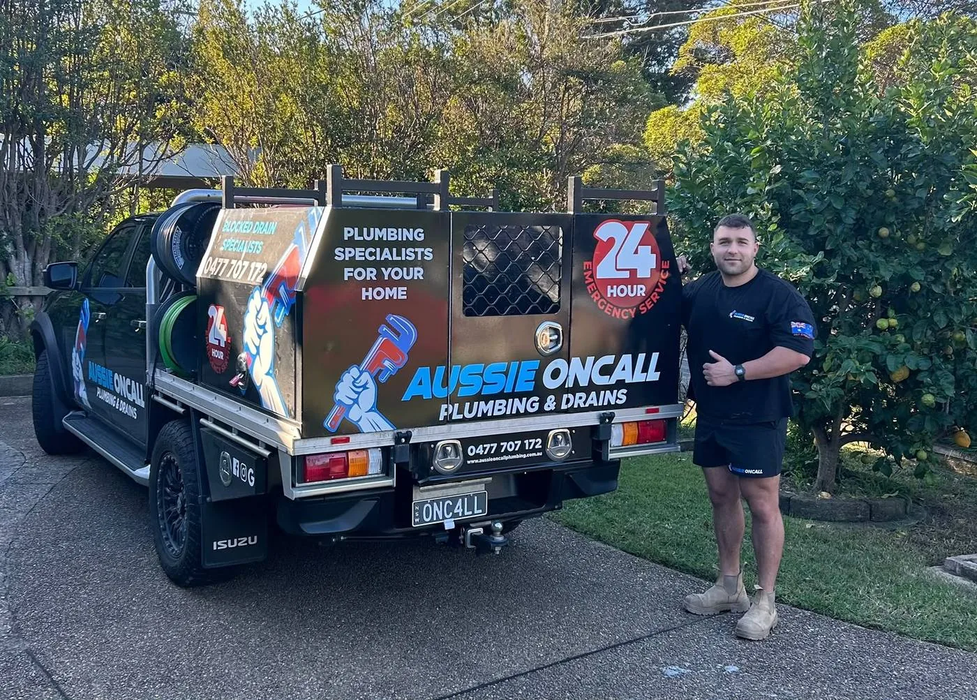 Zack, owner of Aussie Oncall Plumbing & Drains, beside the 24-hour ute